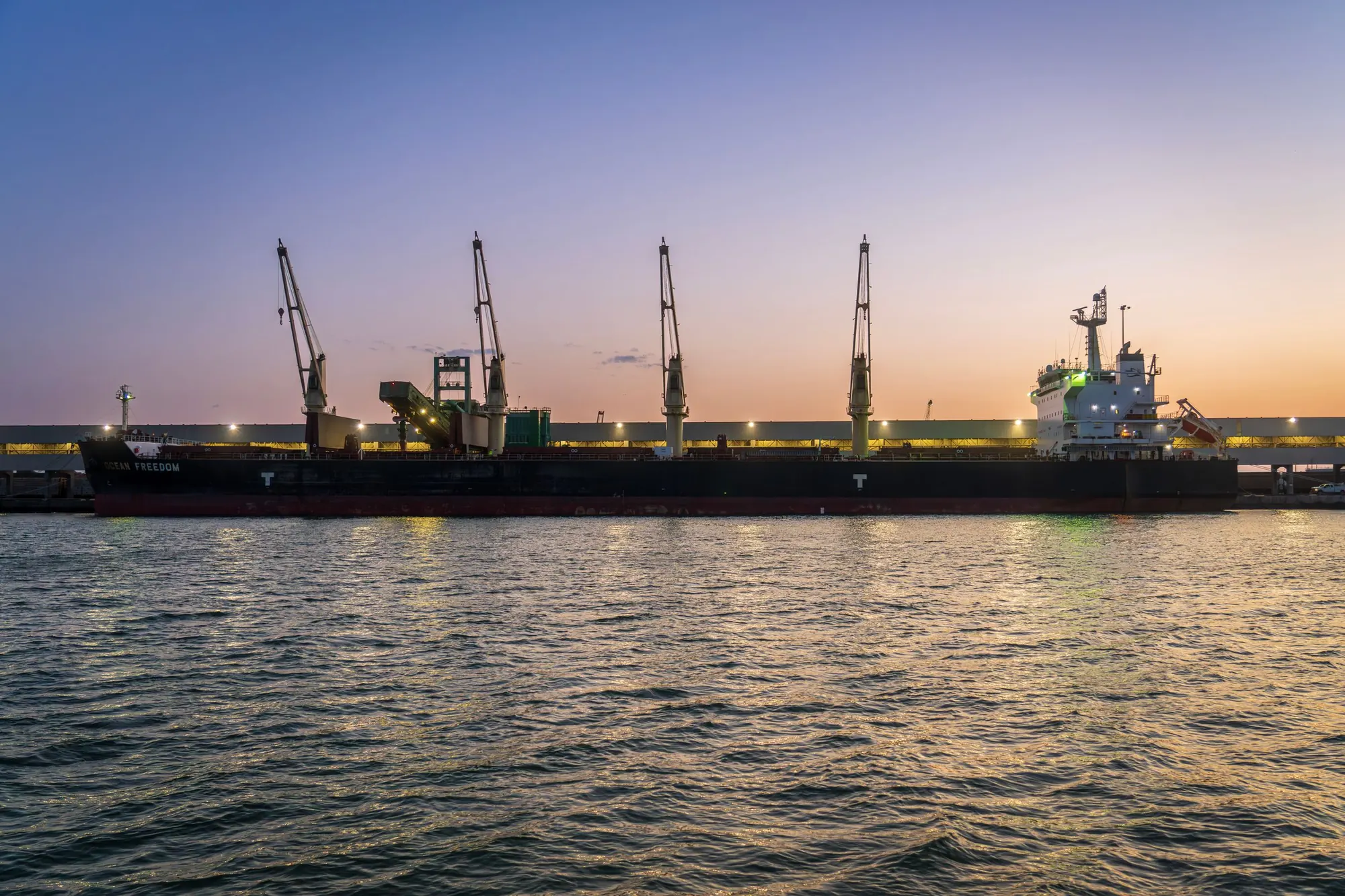 Bulk carriers alongside at dusk