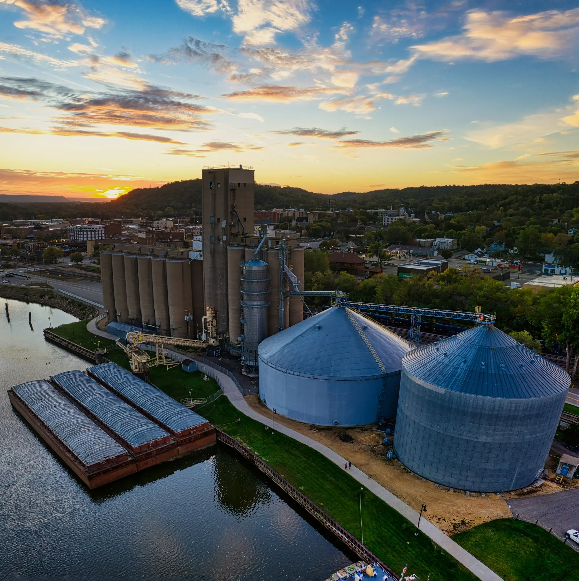 Grain silos and barge terminal at sunset